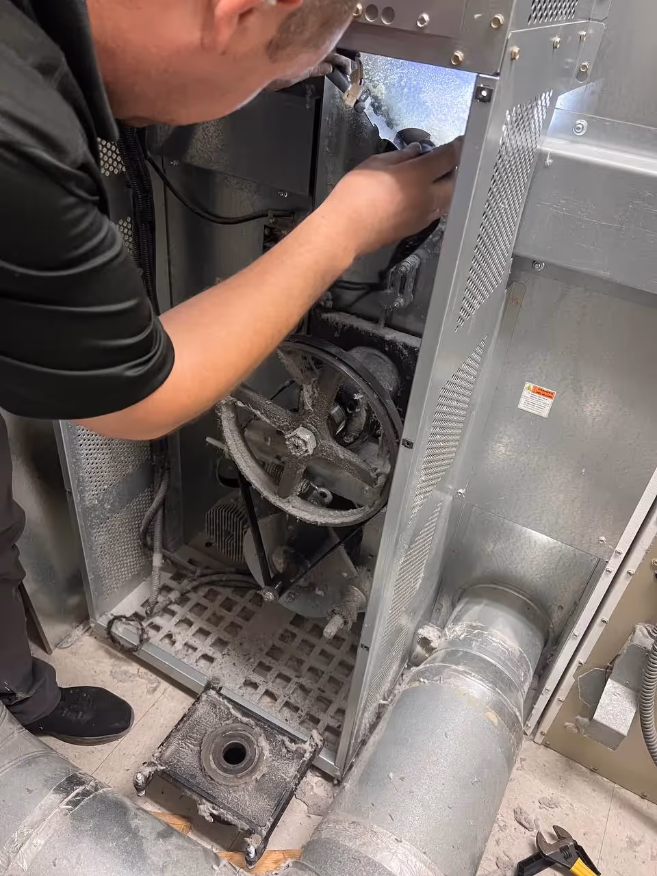 Appliance repair technician repairing a washer
