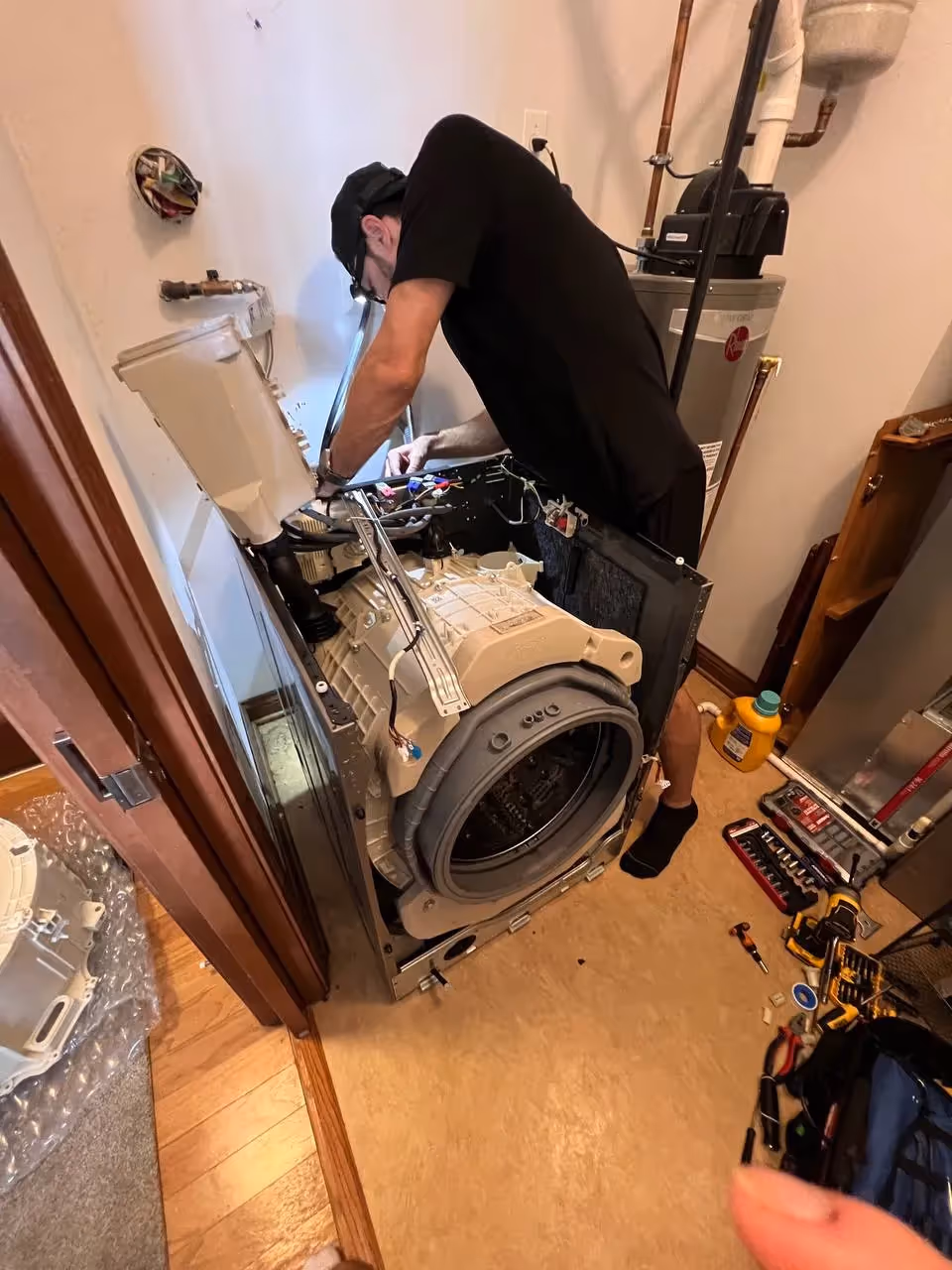 Appliance repair technician repairing a washer