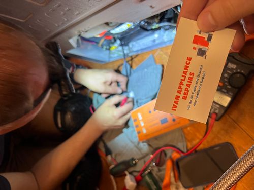 technician repairing refrigerator