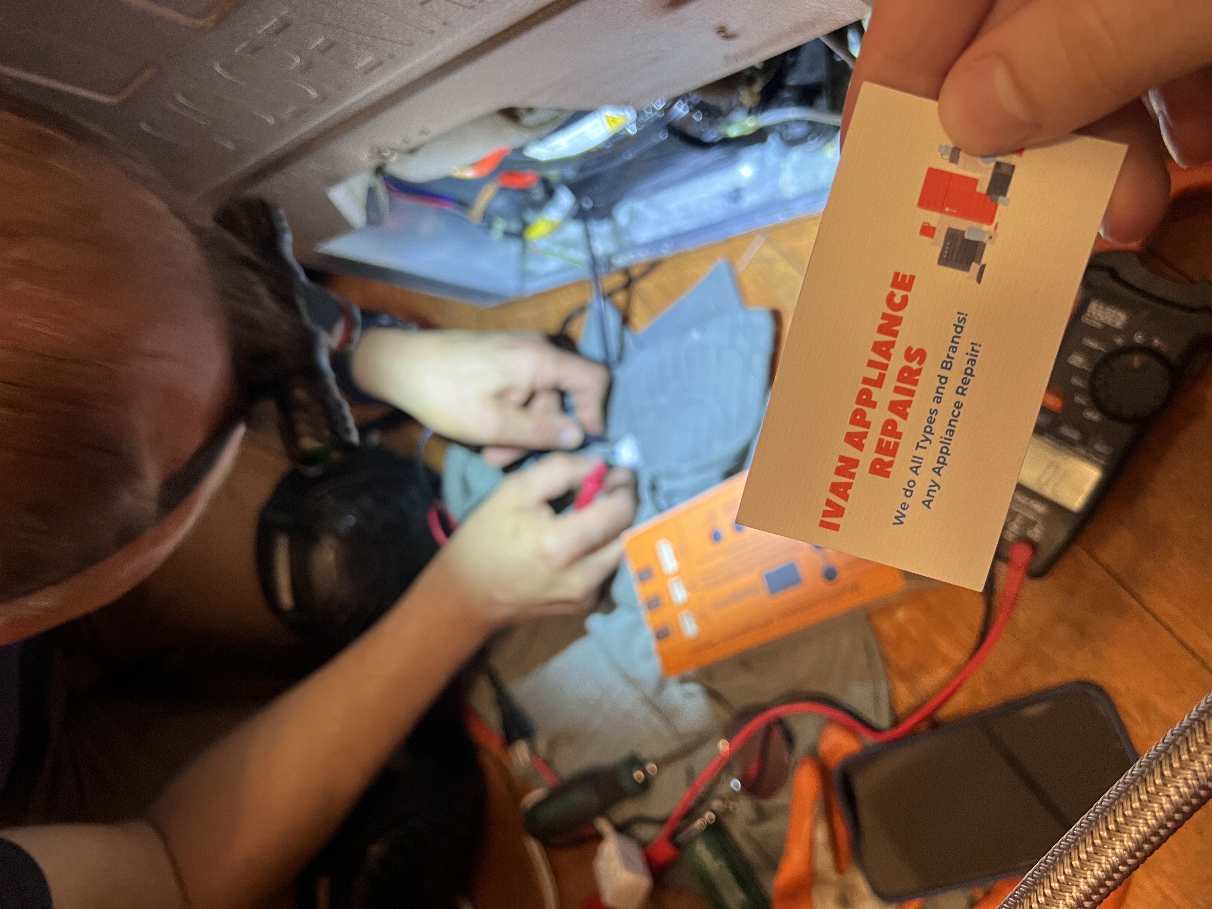 technician repairing refrigerator