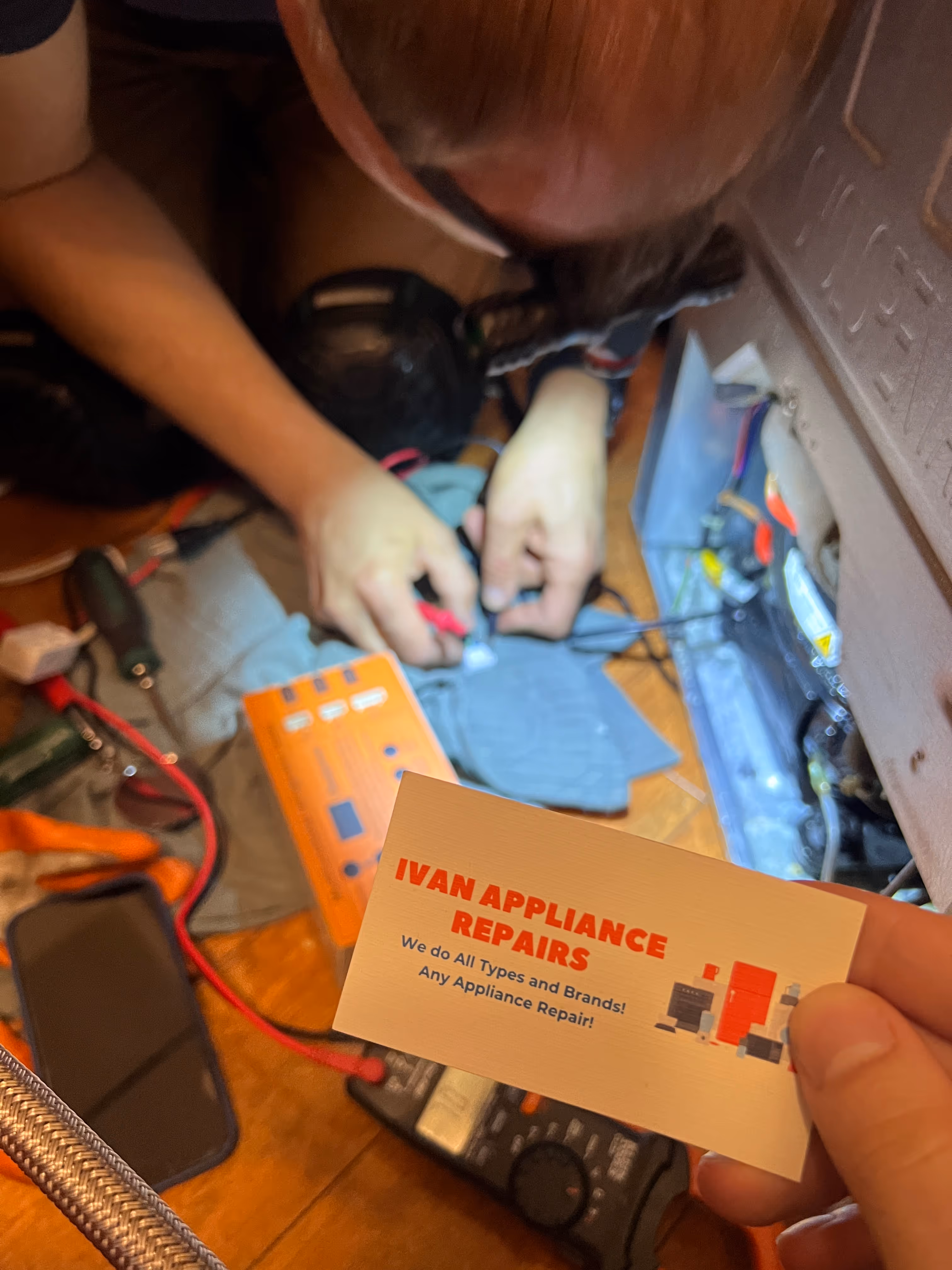 technician repairing refrigerator