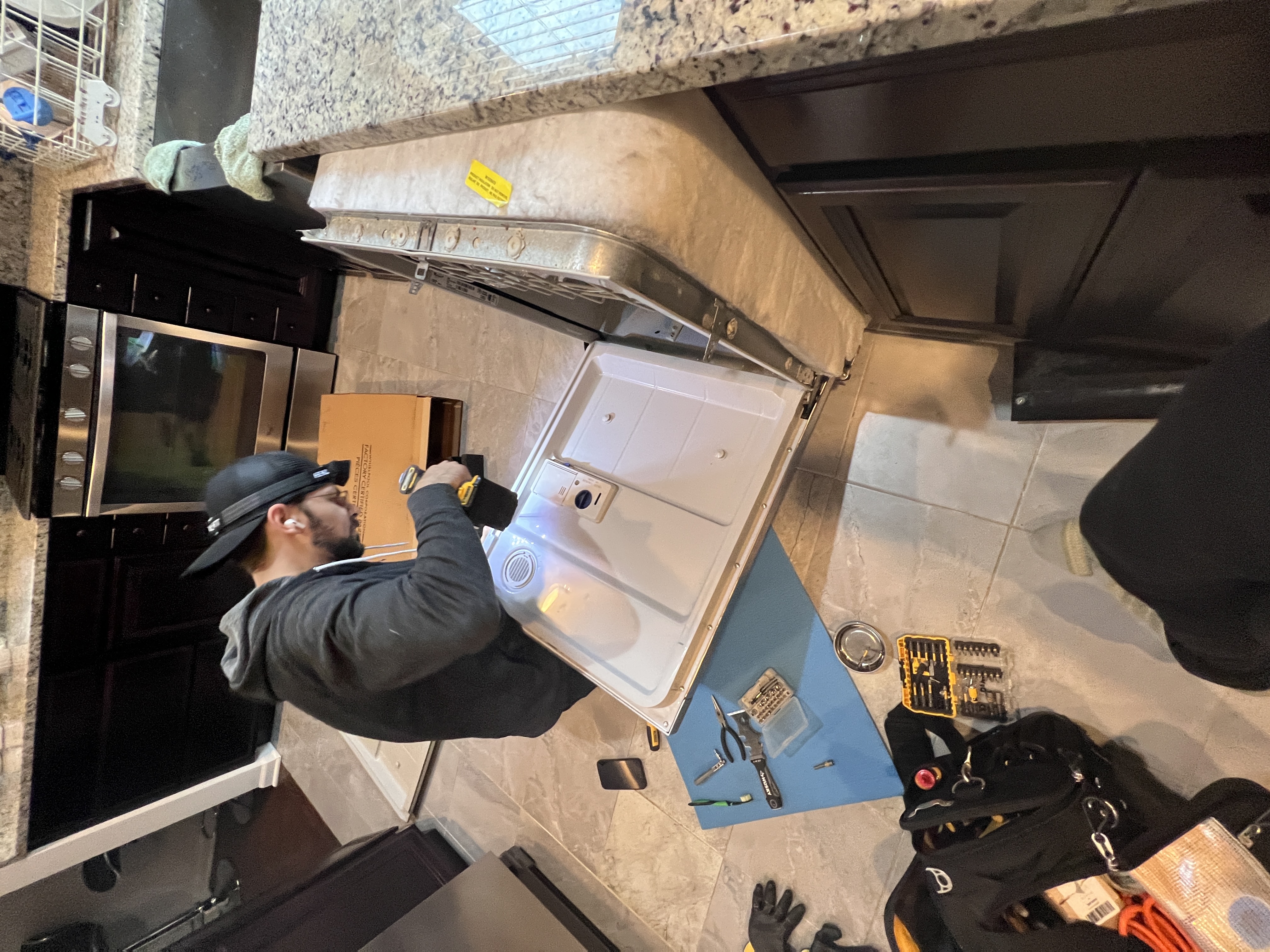 Appliance repair technician repairing a washer