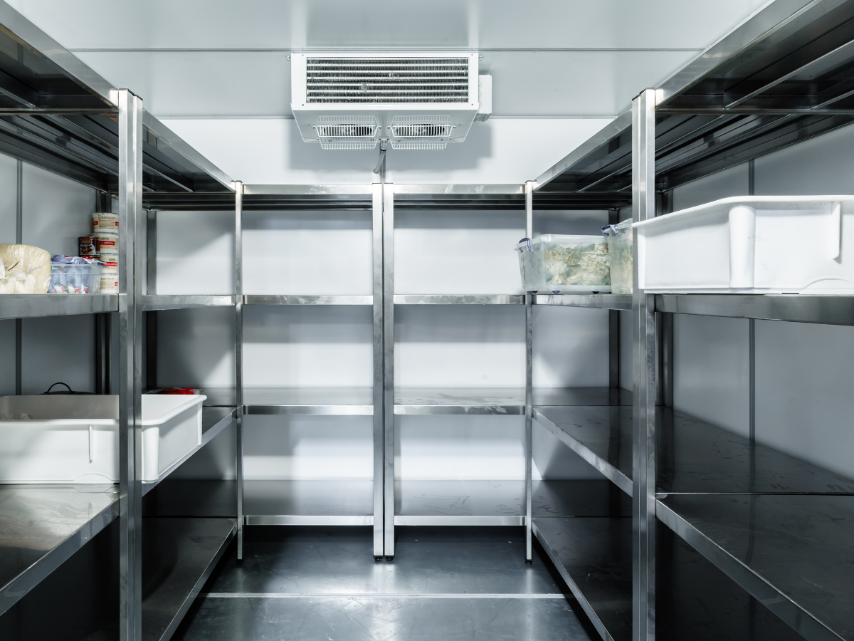 Empty walk-in cooler with stainless steel shelving
