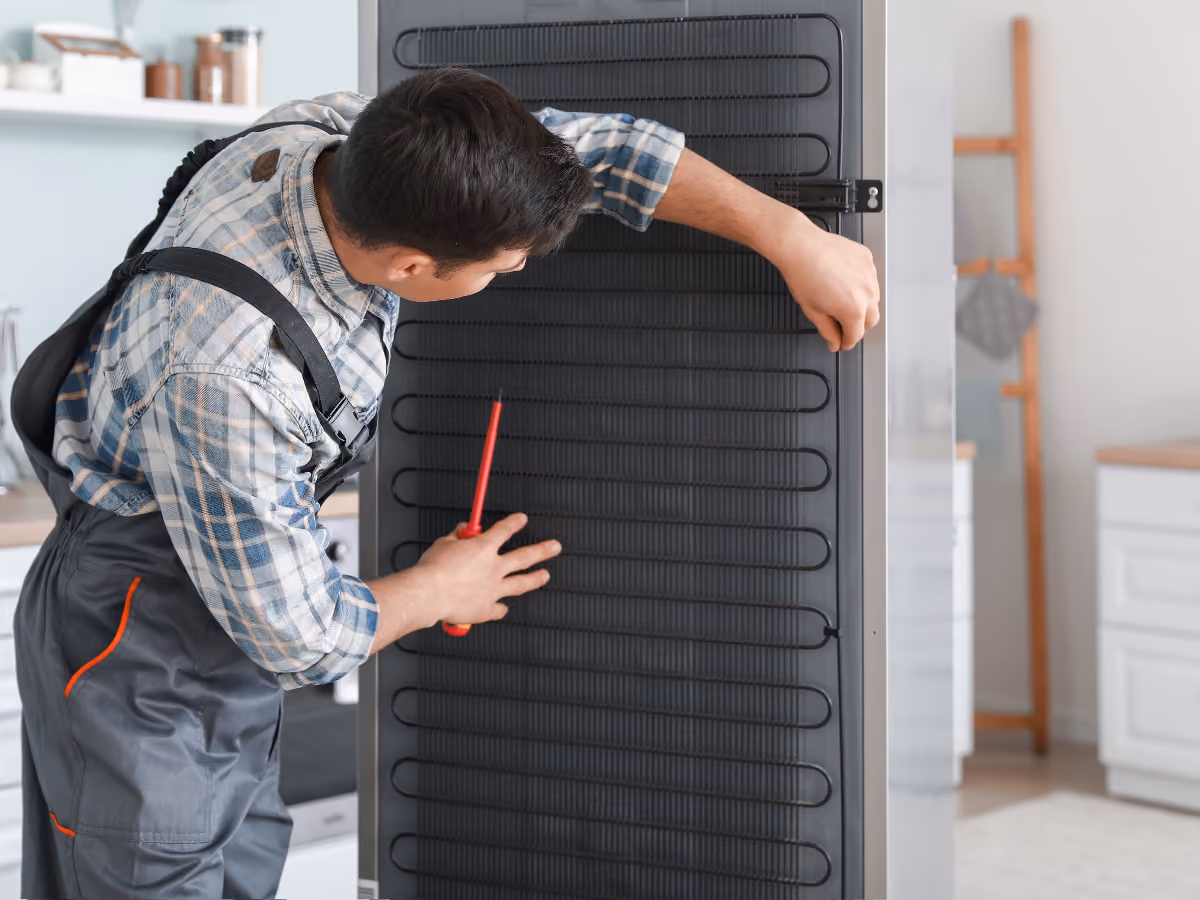 Appliance repair technician repairing a washer