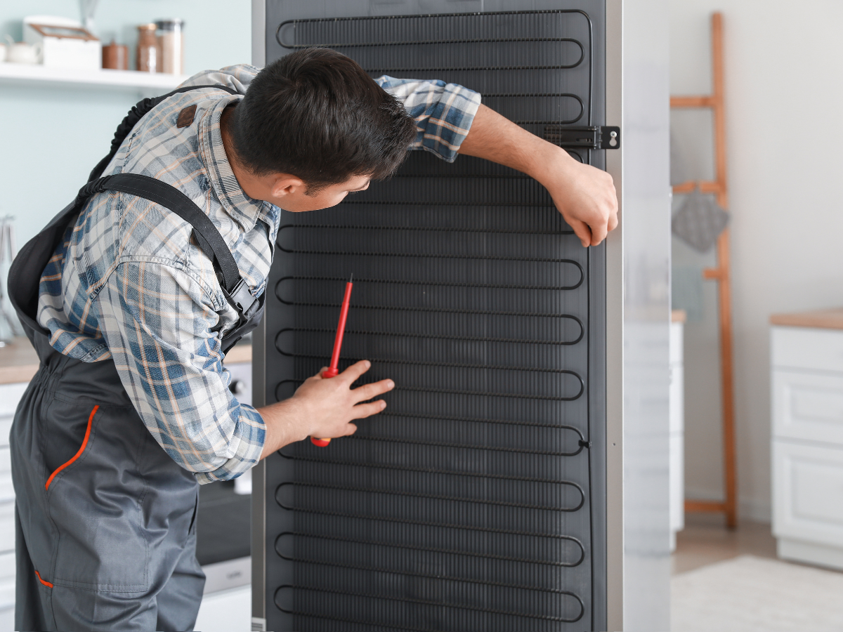 Appliance repair technician repairing a washer