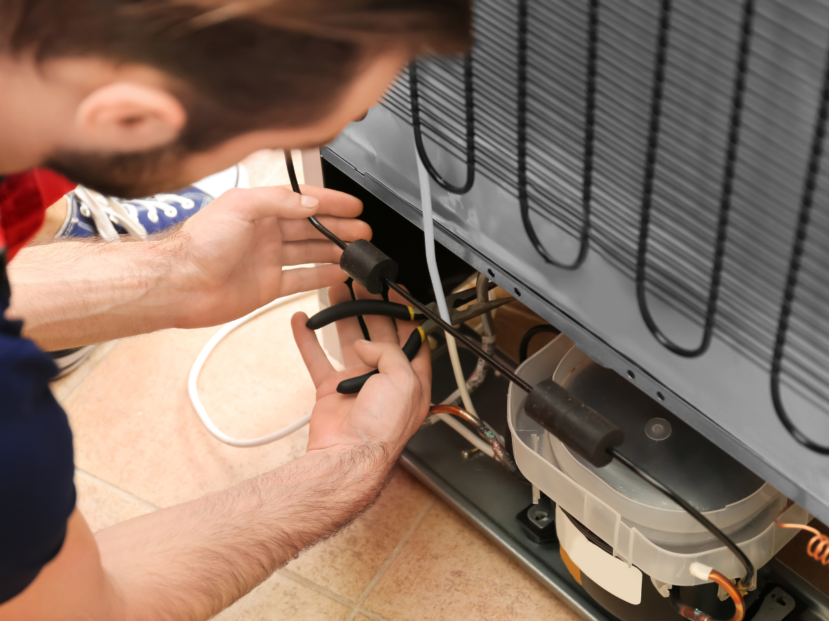 Appliance repair technician repairing a washer