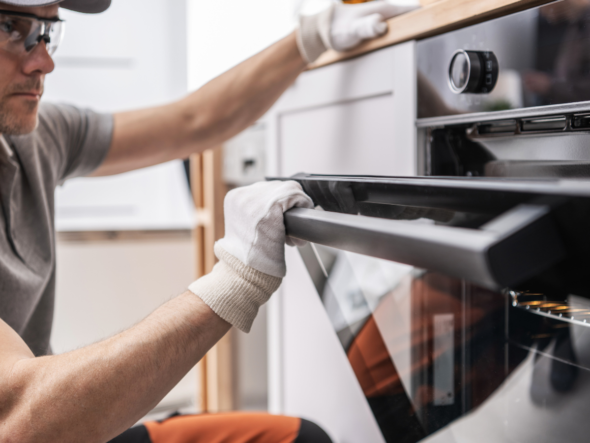 technician checking range oven