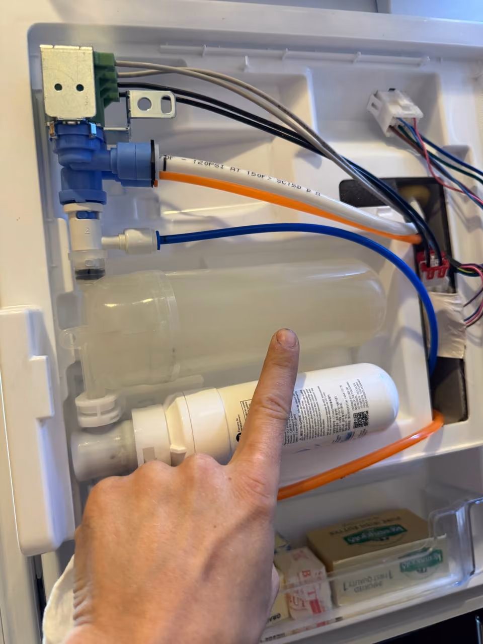 Appliance repair technician repairing a washer