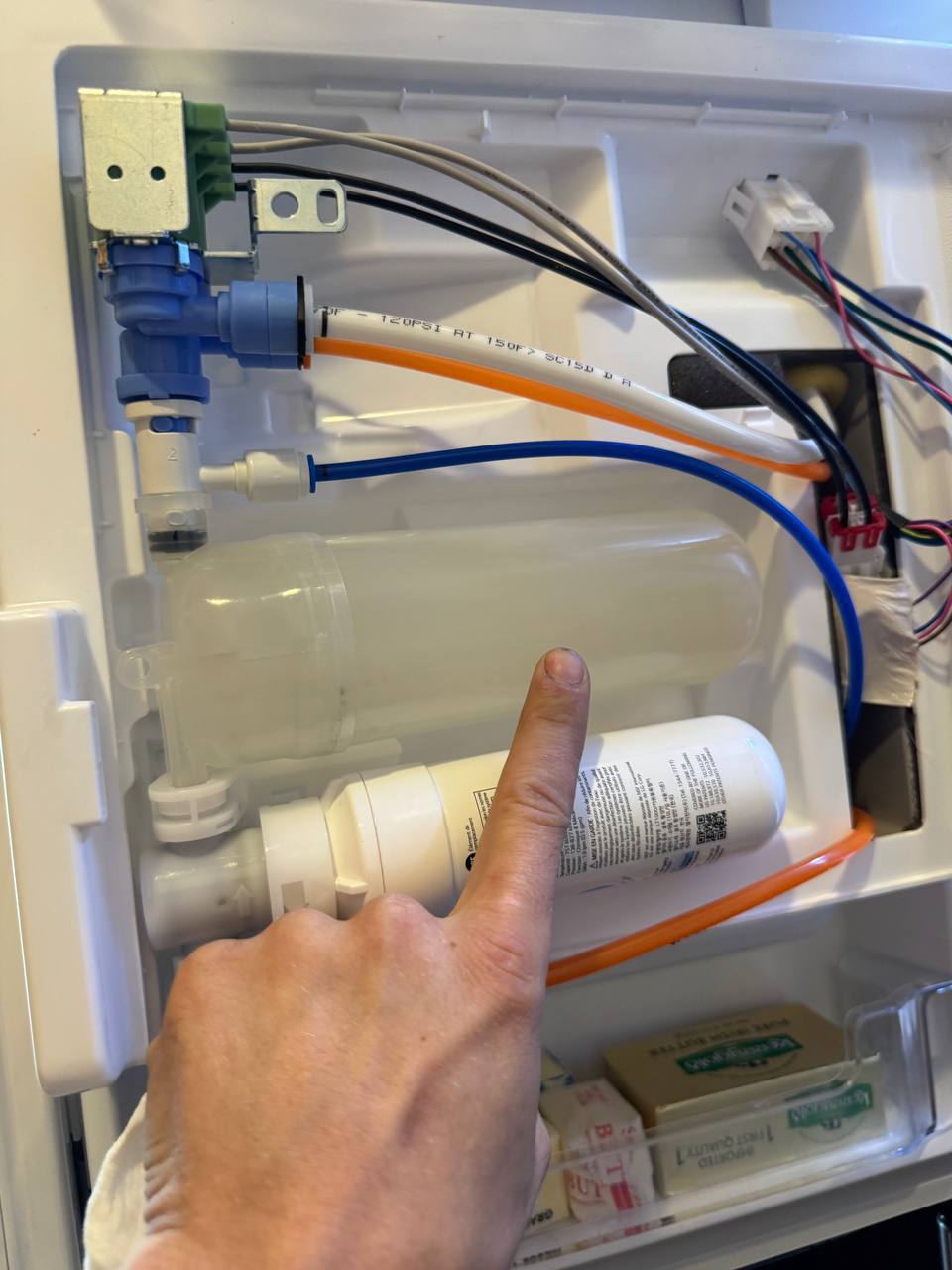 Appliance repair technician repairing a washer