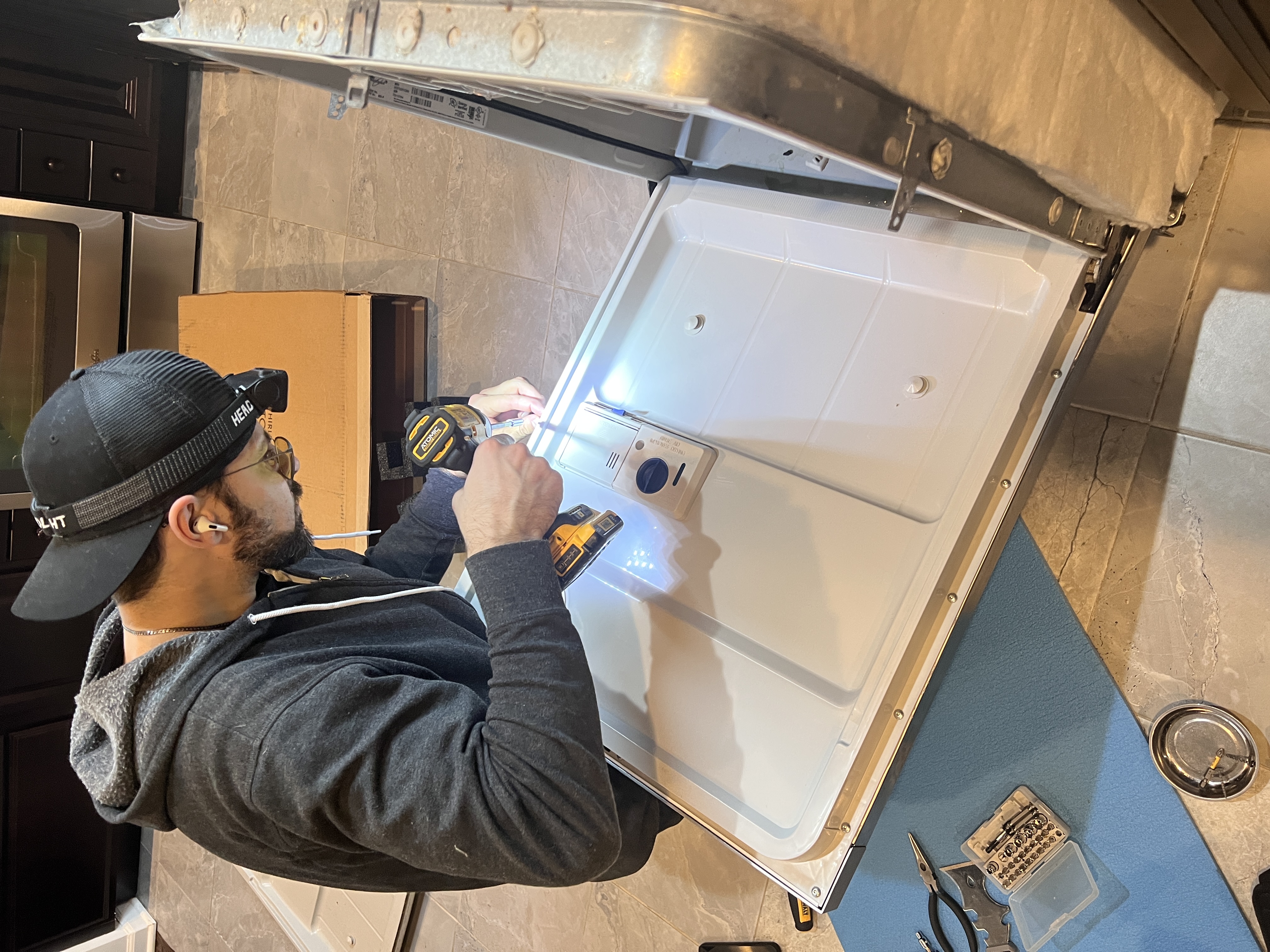 Appliance repair technician repairing a washer