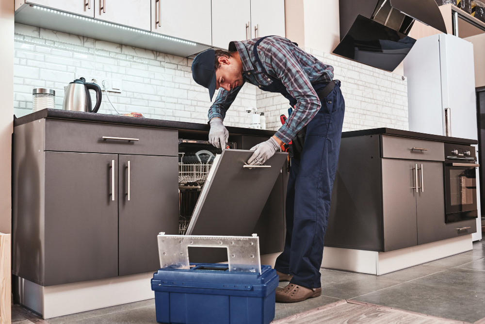 Technician diagnosing dishwasher during professional kitchen appliance repair