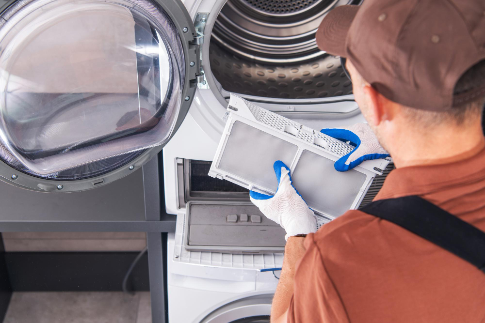 Close up of technician installing clean lint filter inside front load dryer