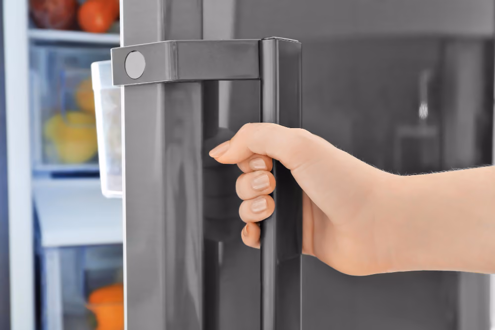 Woman closing refrigerator door closeup