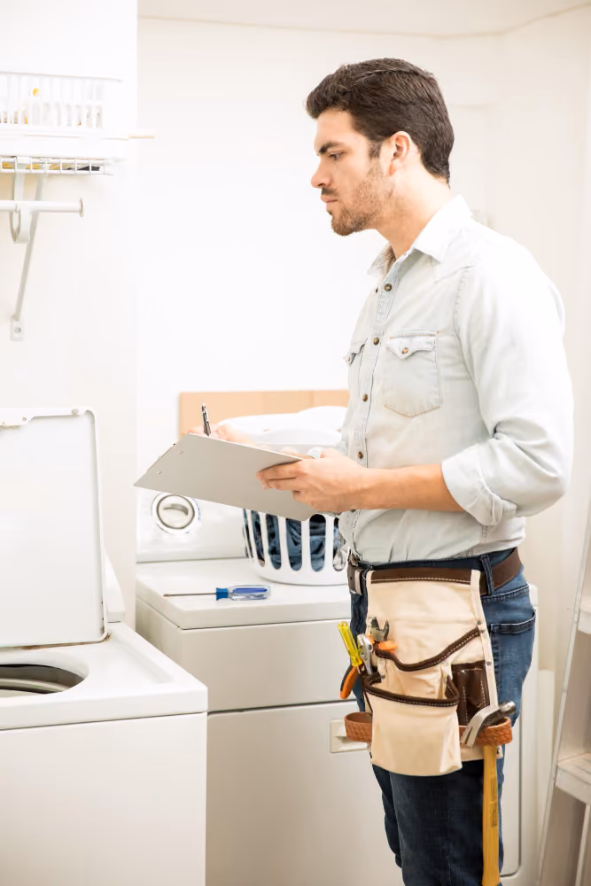 Appliance repair technician repairing a washer