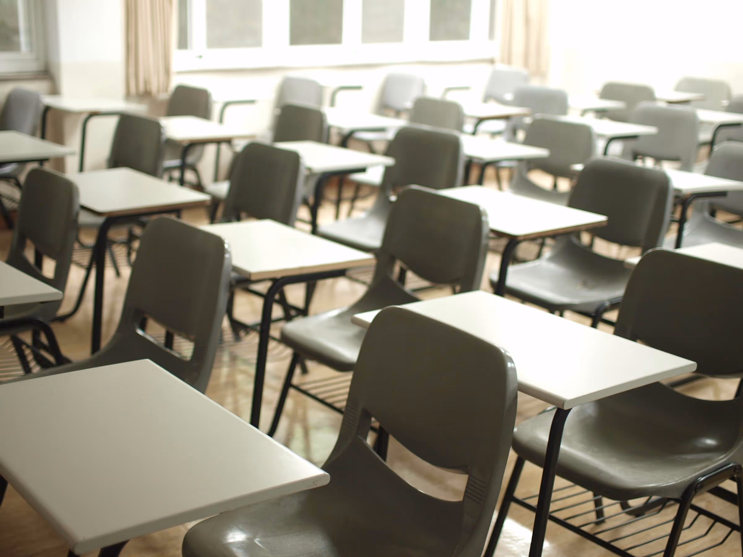 Empty desks and chairs in a school classroom