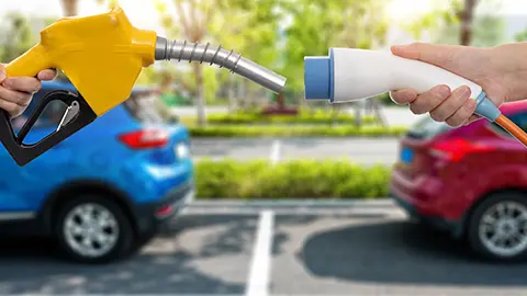 two hands holding an ev charger vs a person who prefers gas