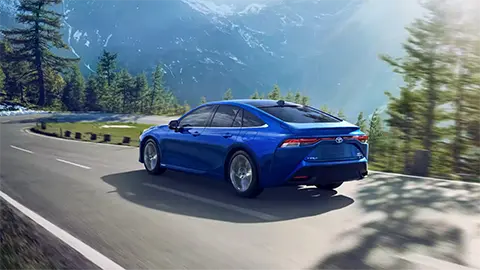 a Toyota Mirai on a road by the lake