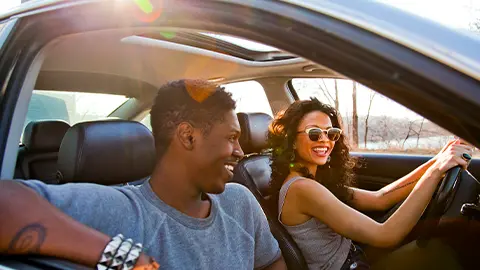Happy couple in car on a nice sunny day