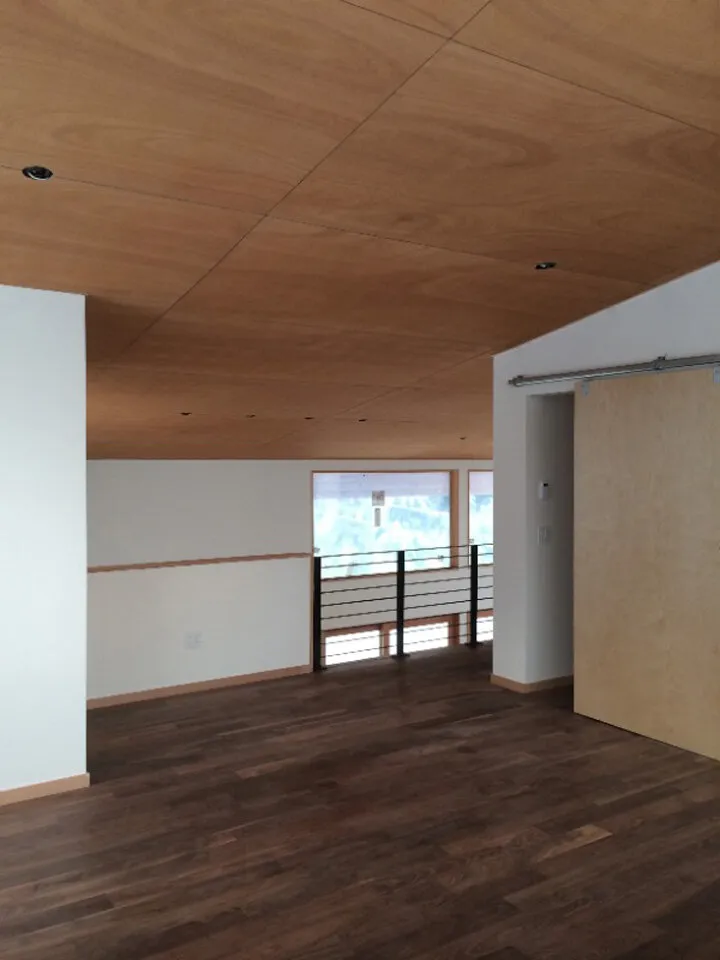 Upstairs loft area with Walnut hardwood floors and Okume plywood ceilings.
