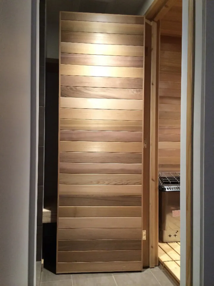 Custom clear Cedar Sauna. The interior features a bench made of reclaimed Fir.