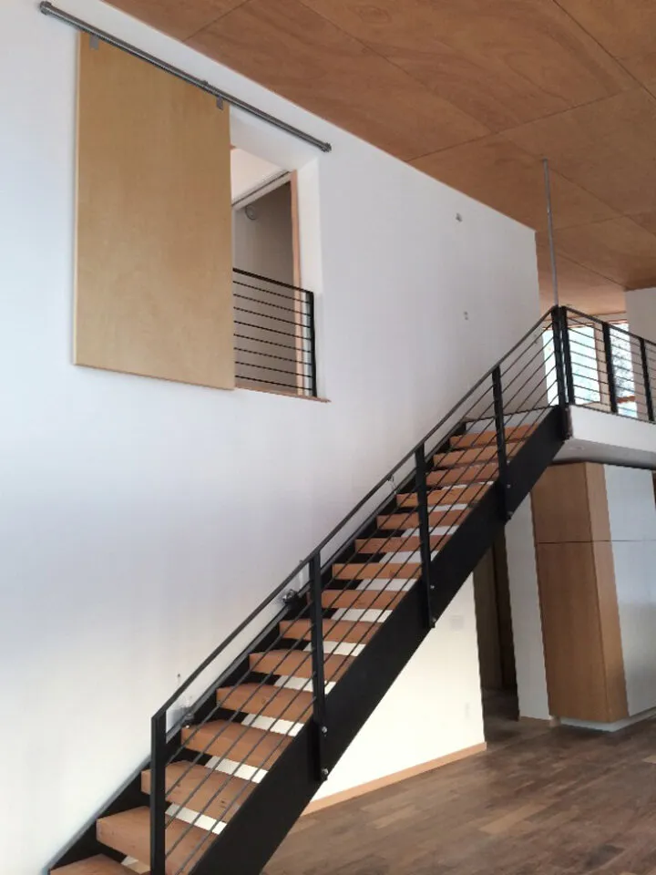Wood and steel stringer staircase and above, a custom loft lookout from the master bedroom.