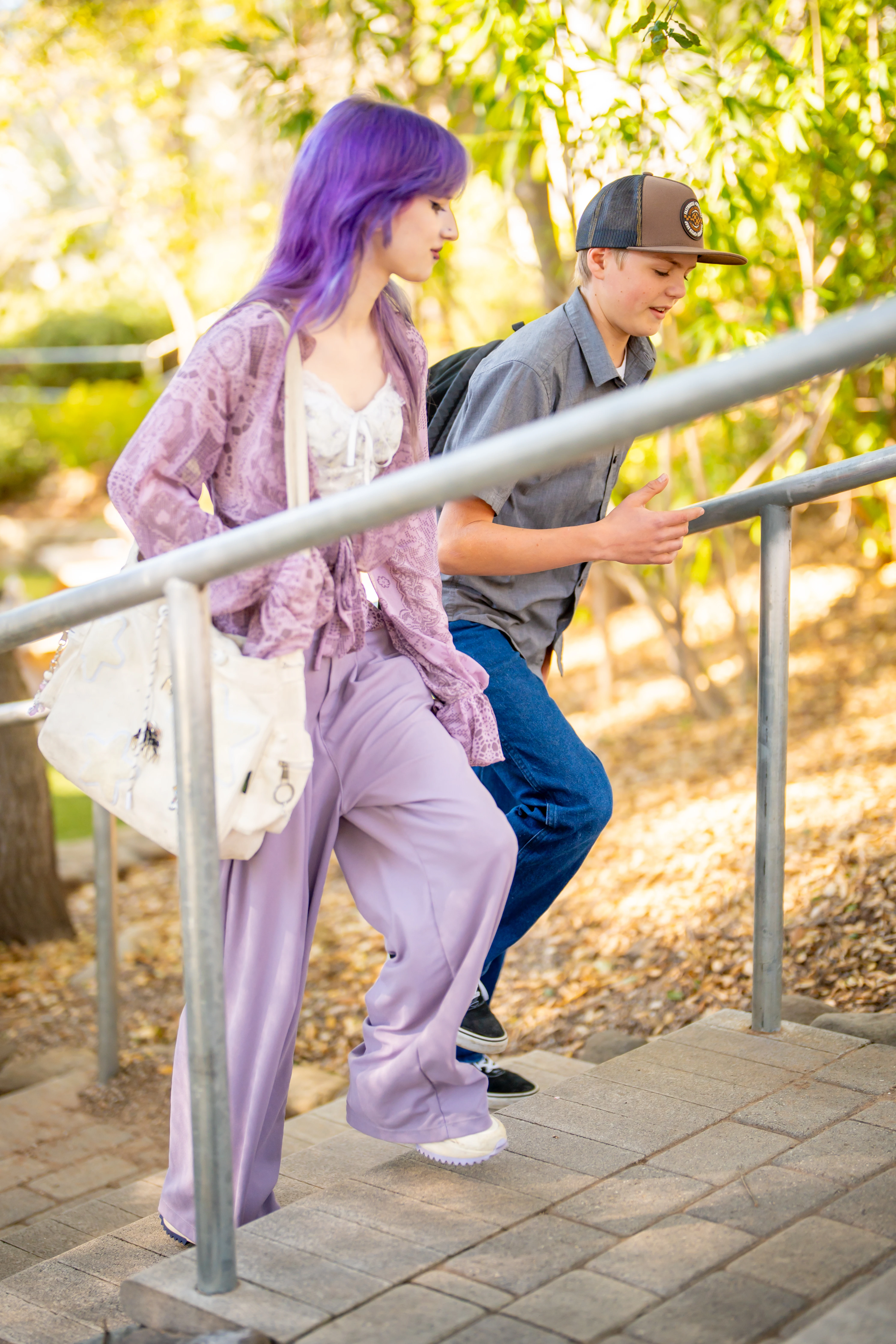 Two students walking up outdoor steps