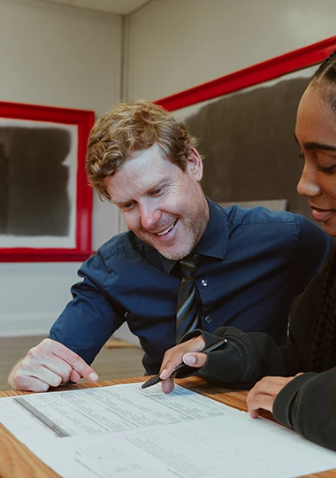 Teacher smiling while marking work
