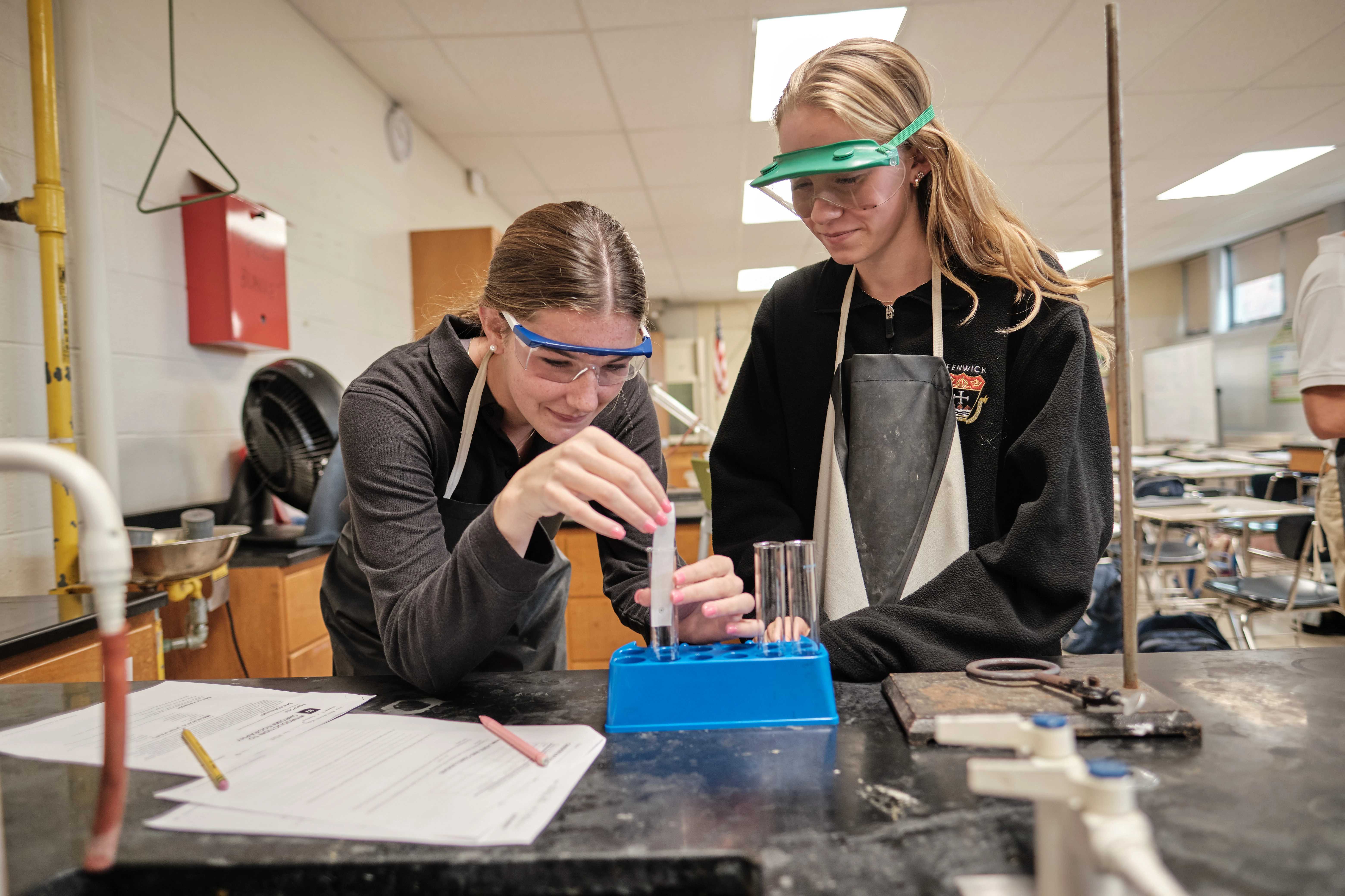 Bishop Fenwick students with safety glasses doing a science experiment