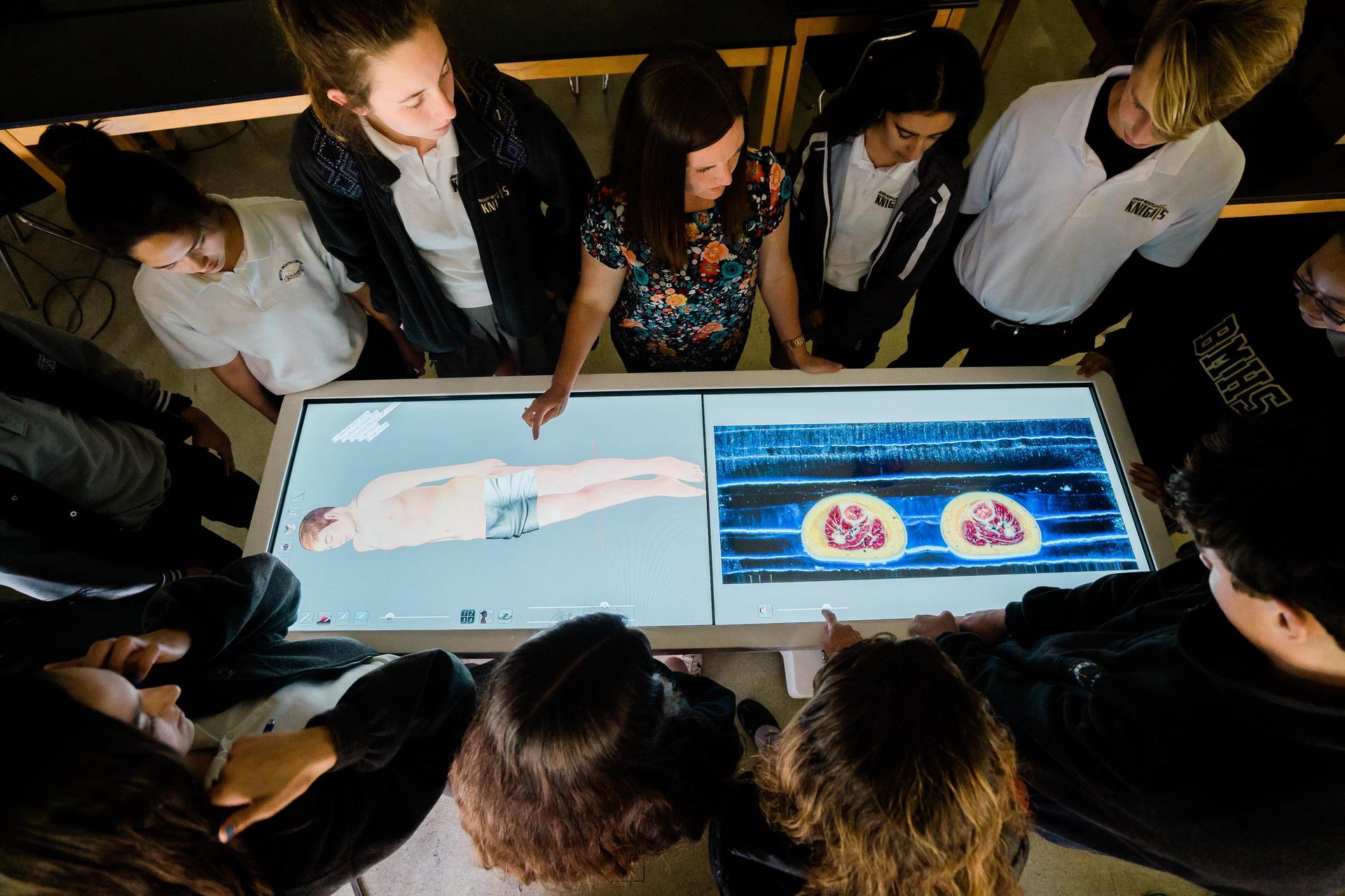 Bishop Montgomery students using a digital anatomy table
