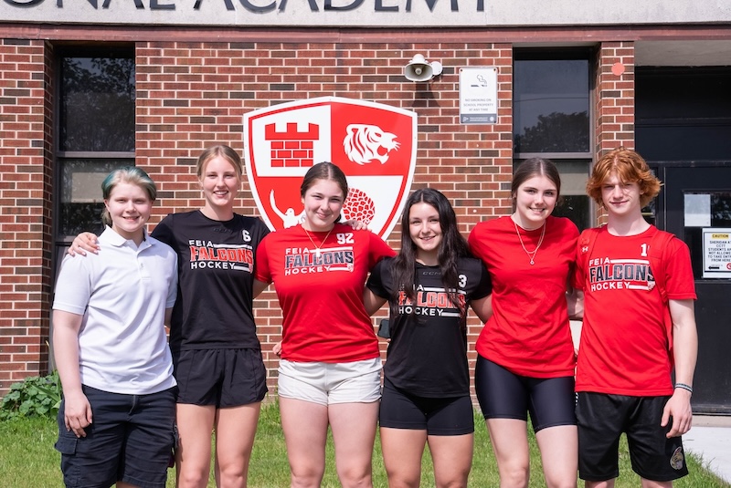 Fort Erie International Academy students in red school T-shirts outside the school