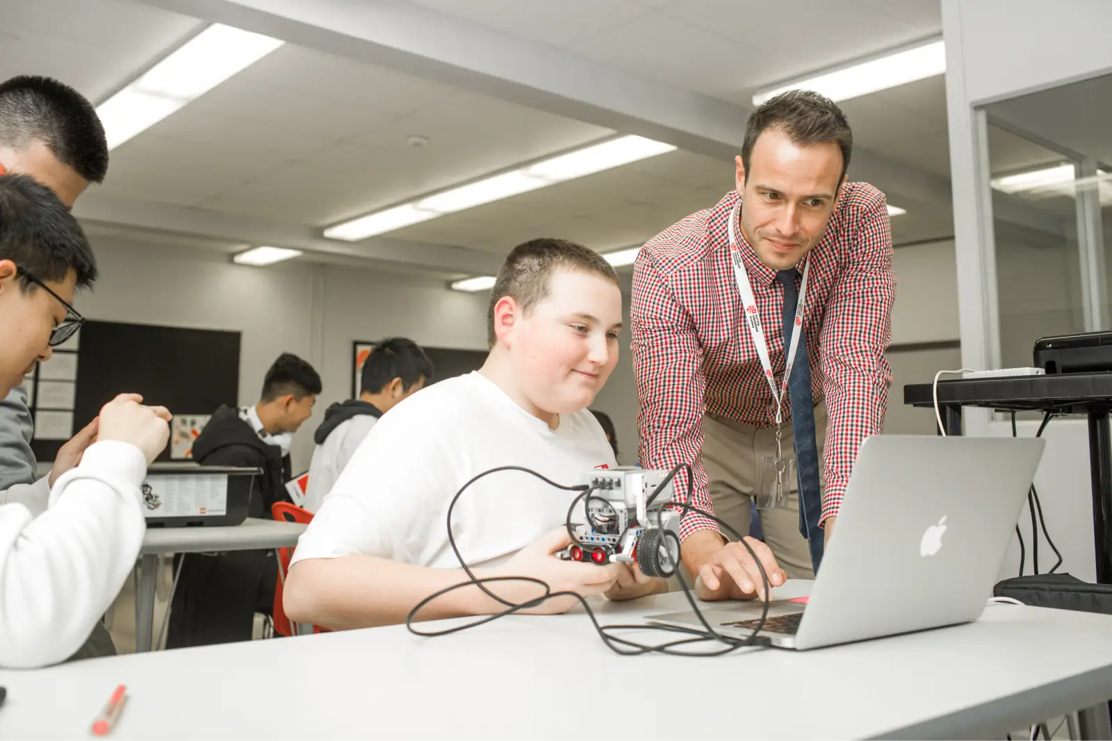 Fort Erie teacher helping a student with a robotics project