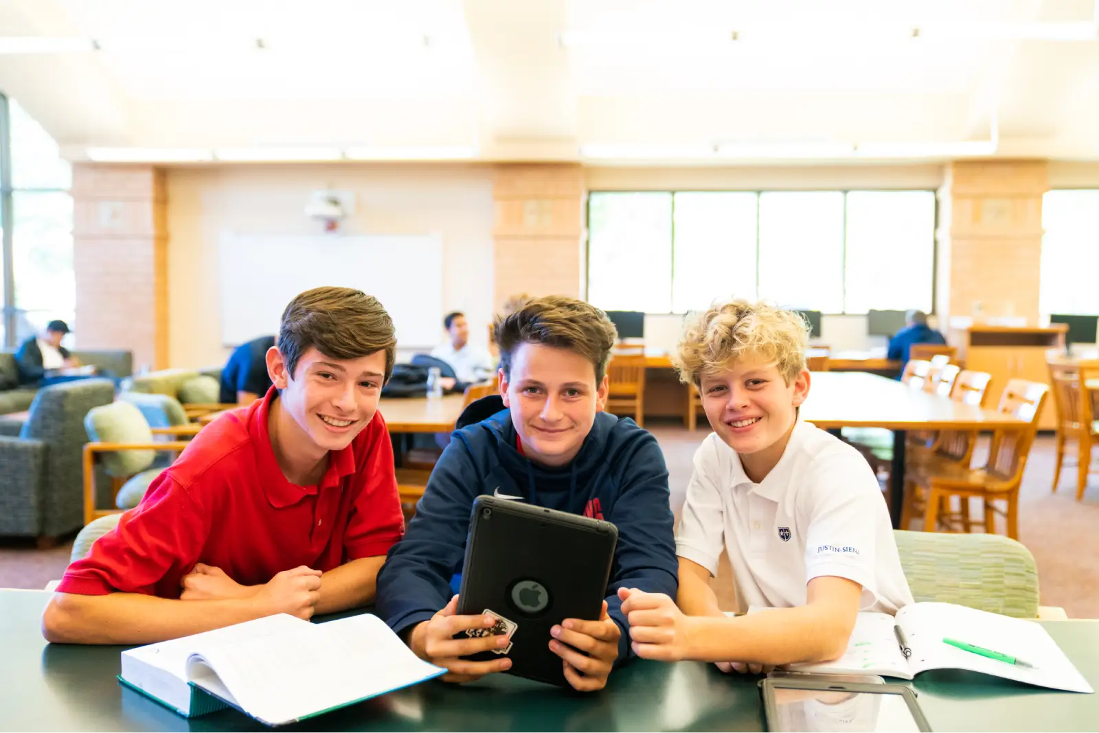 Justin-Siena students studying together with a tablet