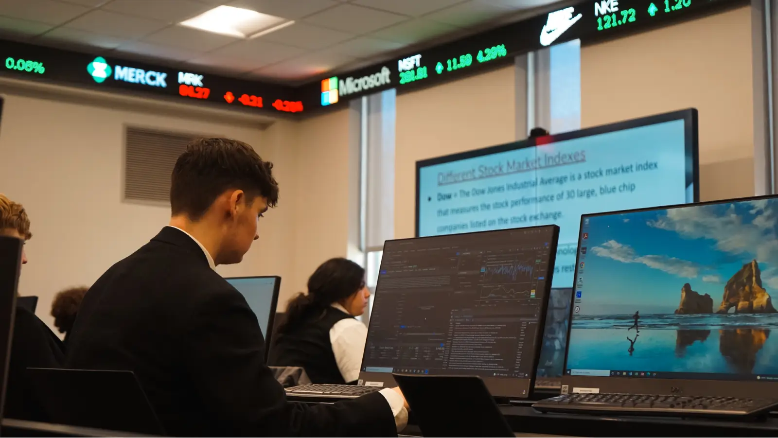 Saint Anthony's students in a finance classroom with stock market screens