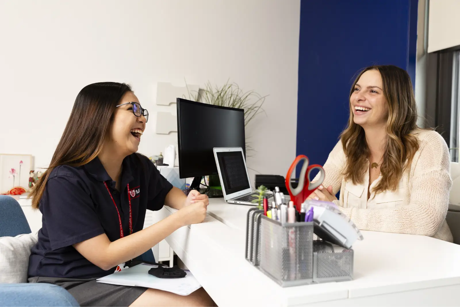 Saint John's student and counsellor laughing together