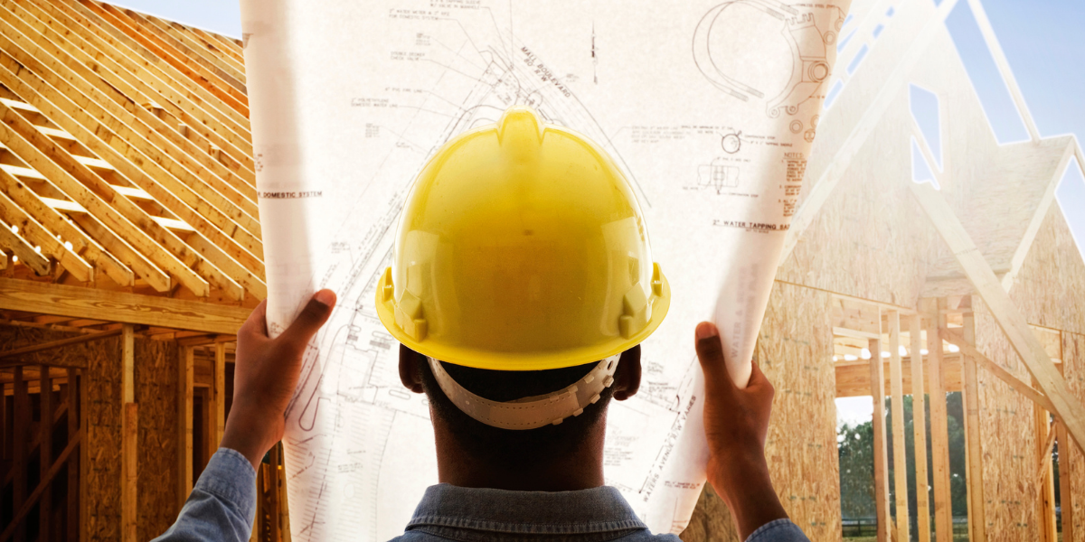 a builder looking over the blueprints