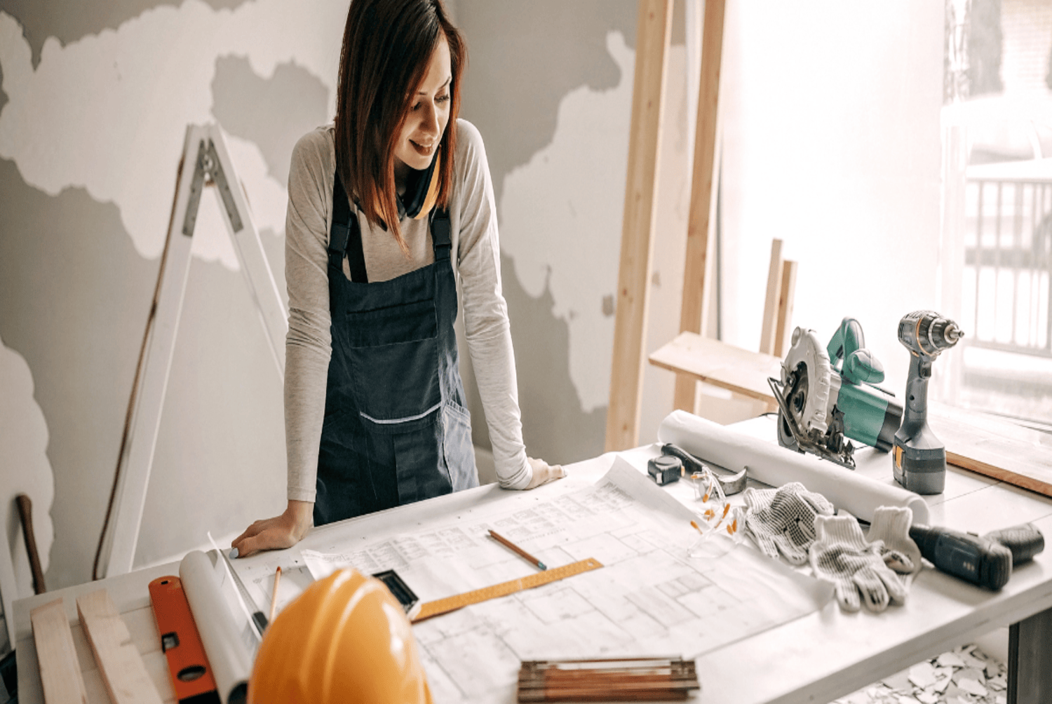 woman looking at the remodeling plans on her desk
