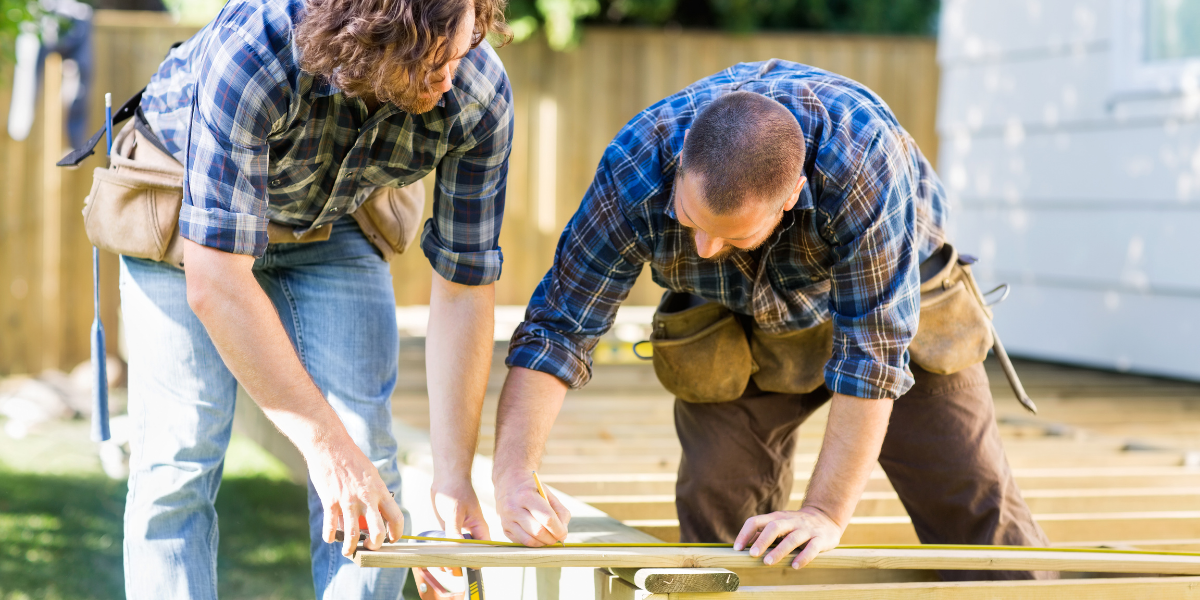 two men building a deck