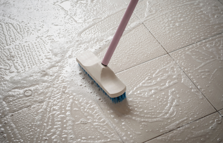 Cleaning a tile floor after a sewage backup.