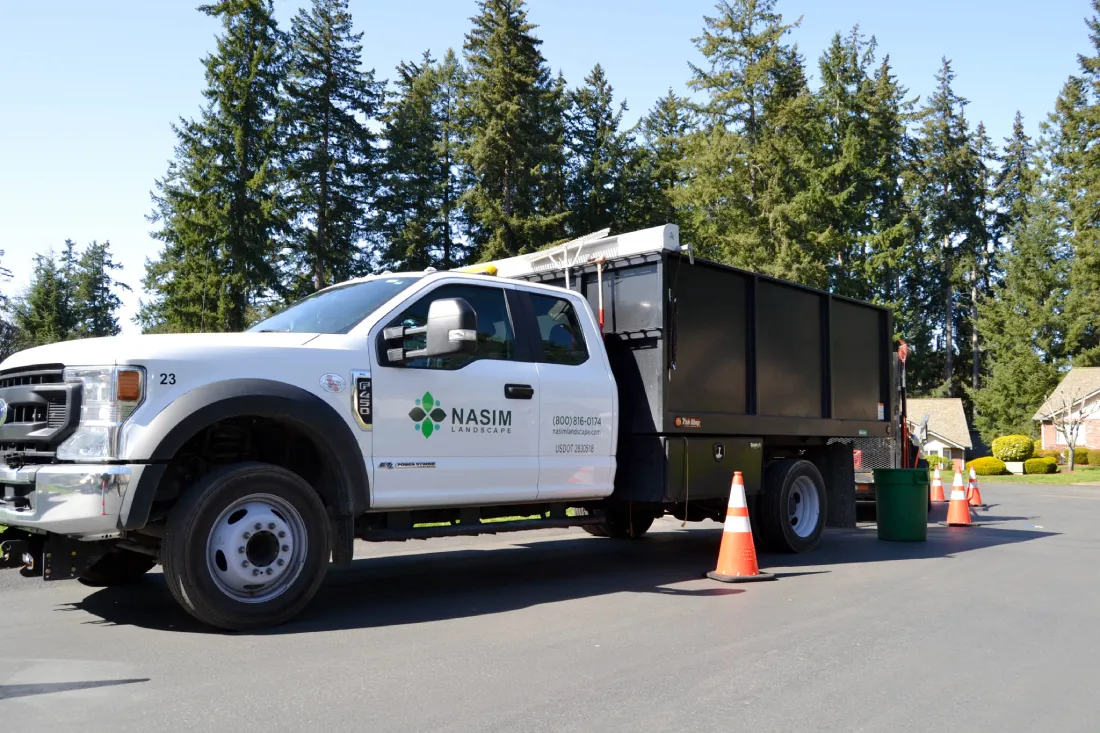 A Nasim Landscape service truck parked on-site at the Springwater HOA project, equipped with tools for professional landscaping.
