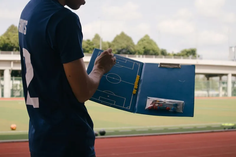 Coach with a empty playbook to start planning a soccer match