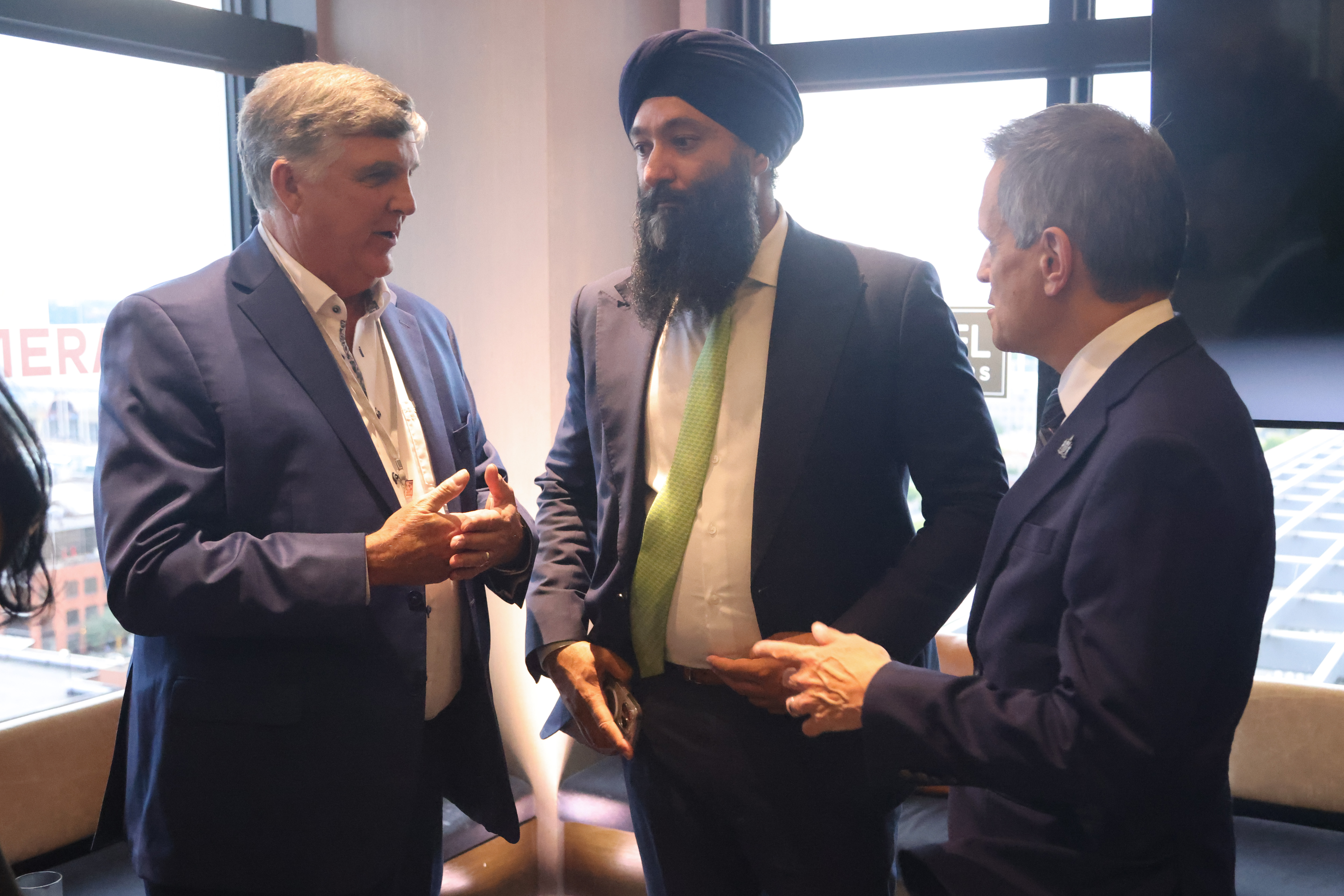 Prabmeet Sarkaria, Ontario Minister of Transportation, stands with Ottawa Mayor Mark Sutcliffe and Roger D’Hollander, COO of Damera, during the AMO 2025 conference.