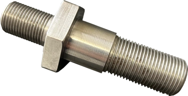 A metal component made by KT Machining. It is a double-sided screw that adapts a larger screw into a smaller one, joined together with a hex nut in the middle.