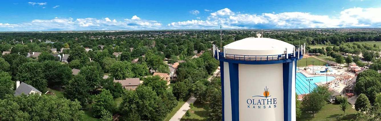 Horizon shot of a Olathe with trees and a water tower.