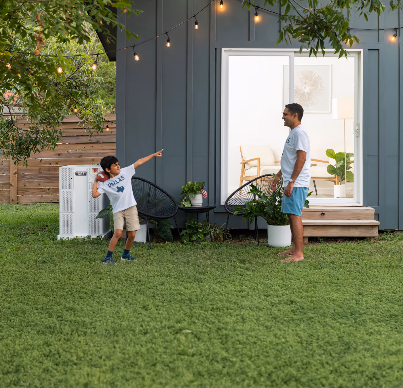 Kid throwing a football in a backyard