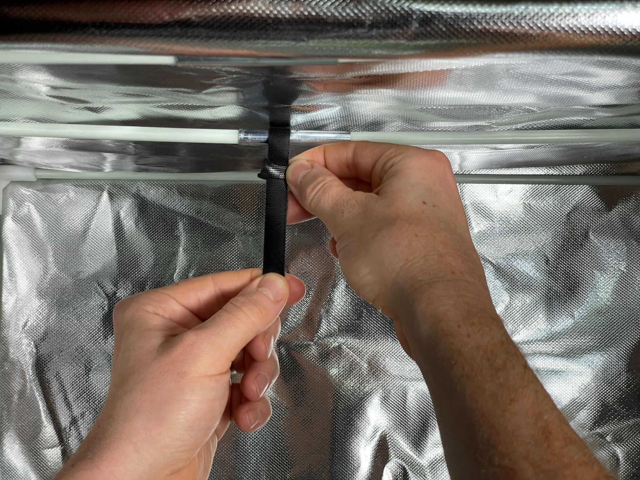 7 Attach the strap to the crossbar