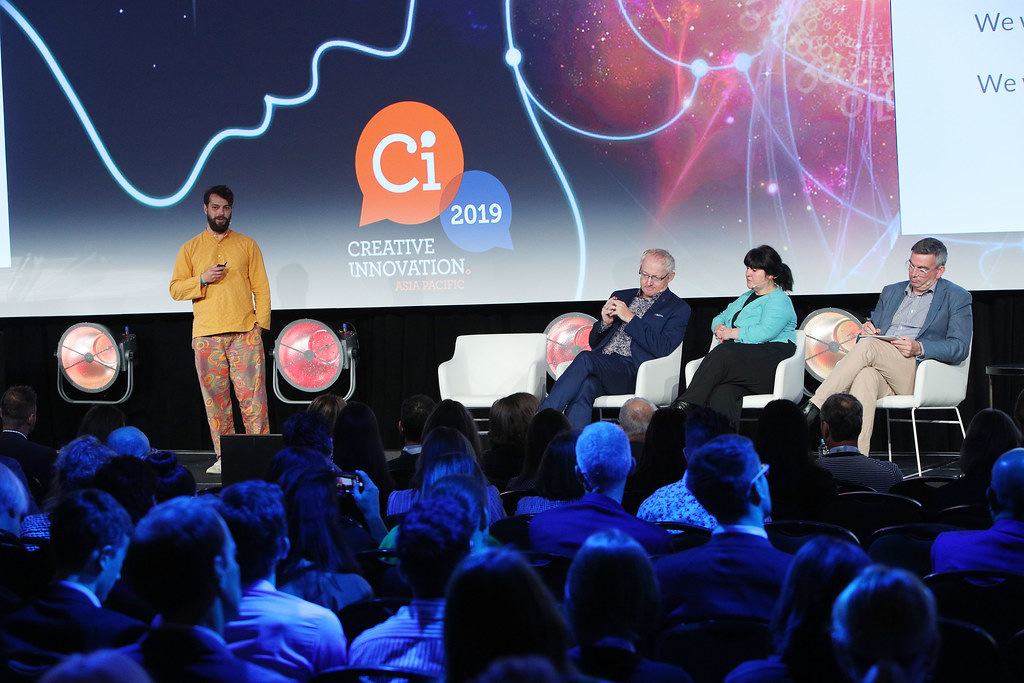 aKin team poses with Minister Ed Husic, with companies robot in centre