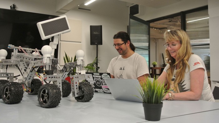 aKin team poses with Minister Ed Husic, with companies robot in centre