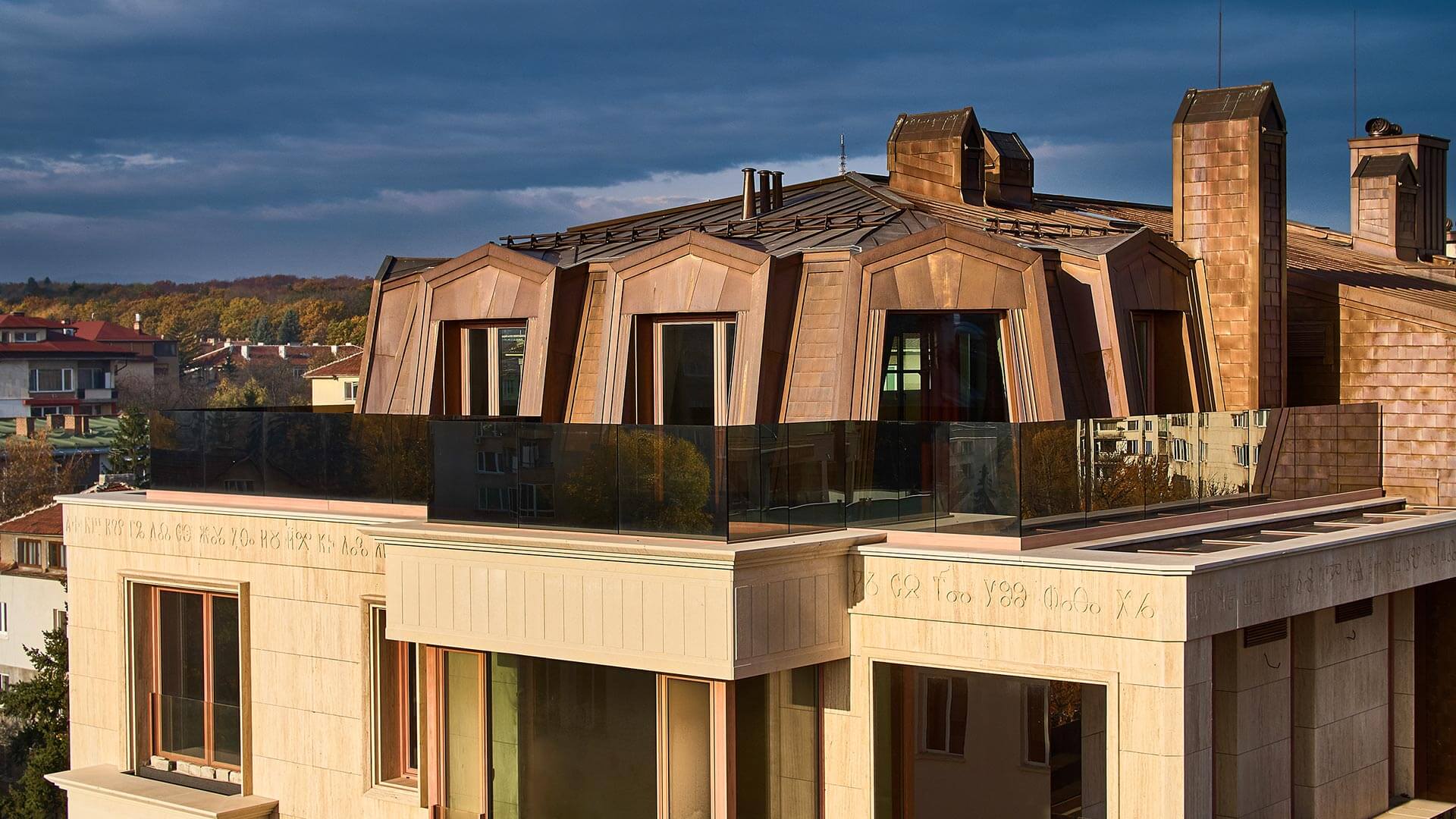 Roof with sheet metal on a luxury building photographed at sunset