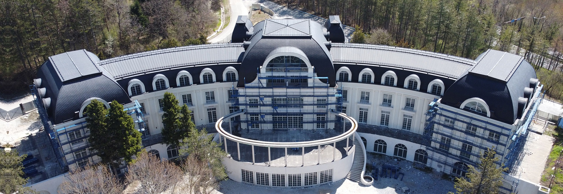 Black sheet metal roof of a luxury hotel, photographed from above