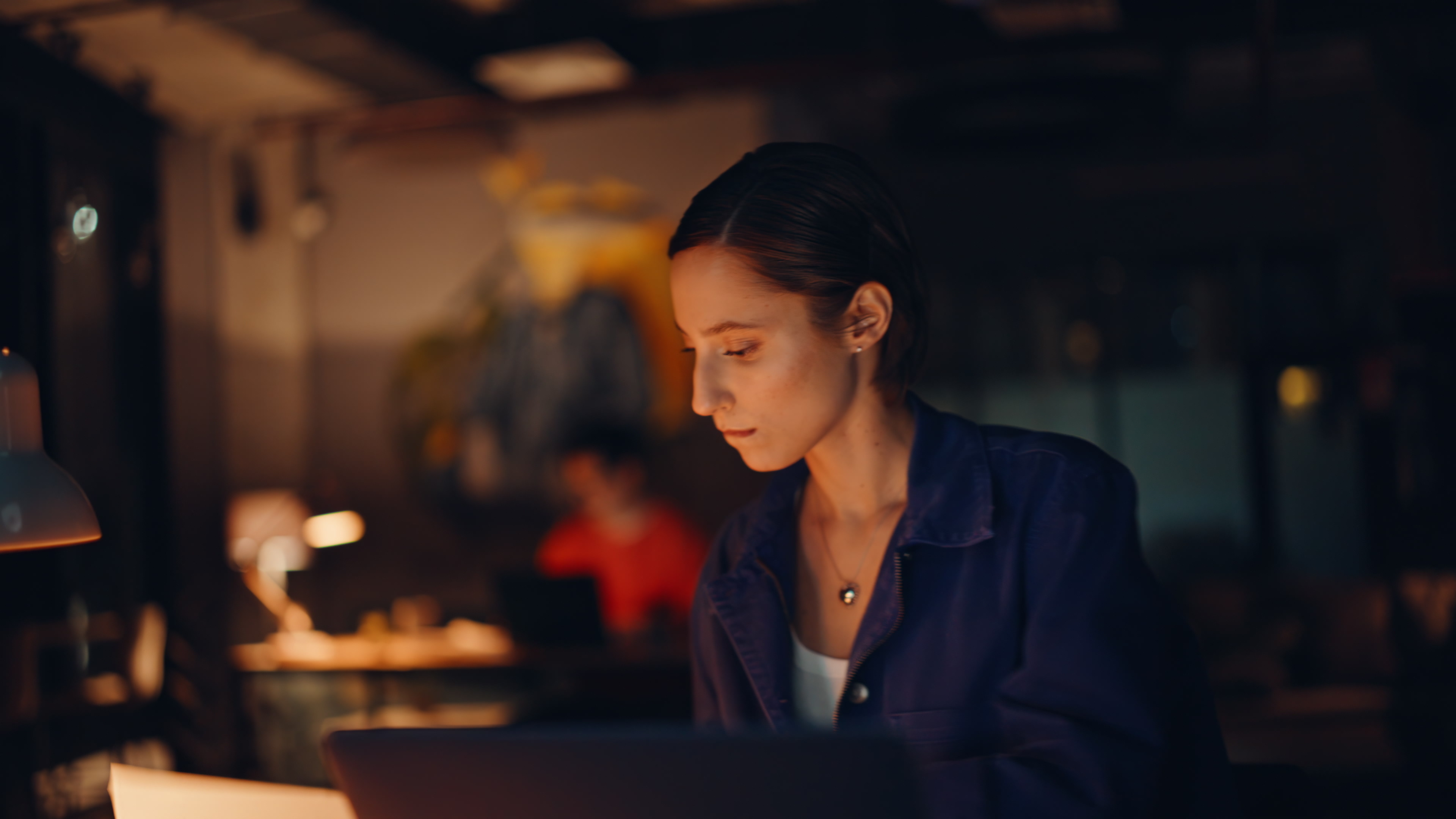 Worried accountant reviewing documents at night office coworking space closeup.